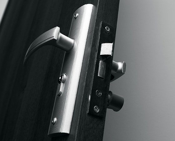 Door lock system with handle, cylinder, and body installed on a wooden door