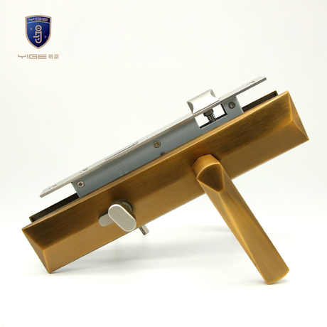 Copper double - side entrance door handle with key latch lock, on a metal display stand among other lock parts